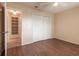 Bedroom with wood floors, double closet, and access to bathroom at 10918 Se 50 Ave, Belleview, FL 34420