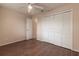 Bedroom with wood floors, closet, and access to bathroom at 10918 Se 50 Ave, Belleview, FL 34420