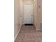 Bright entryway with tile floor, coat closet, and door to interior at 10918 Se 50 Ave, Belleview, FL 34420