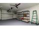 Garage with storage shelving and a ceiling fan at 10918 Se 50 Ave, Belleview, FL 34420