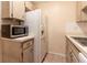 Kitchen includes wood cabinets, microwave, and refrigerator at 10918 Se 50 Ave, Belleview, FL 34420