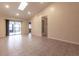 Bright living room with tile floors and sliding doors to patio at 10918 Se 50 Ave, Belleview, FL 34420