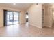 Living room with tile floor, built in shelving and access to patio at 10918 Se 50 Ave, Belleview, FL 34420