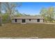 House exterior back view with grey siding and small patio at 13 Bahia Trace Loop, Ocala, FL 34472