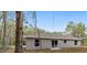 House exterior side view with grey siding, windows and trees at 13 Bahia Trace Loop, Ocala, FL 34472