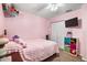 Pink bedroom featuring a double bed and built-in shelving at 13165 Sw 107Th St, Dunnellon, FL 34432