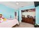 Light blue bedroom with a double bed and a large closet at 13165 Sw 107Th St, Dunnellon, FL 34432