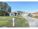 Light green house with a two car garage and mailbox at 13165 Sw 107Th St, Dunnellon, FL 34432