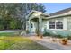 Front porch with rocking chairs and landscaping at 13165 Sw 107Th St, Dunnellon, FL 34432