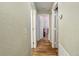 Long hallway with light walls and wood flooring at 13165 Sw 107Th St, Dunnellon, FL 34432