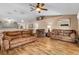 Vaulted ceiling living room with hardwood floors, couches and kitchen view at 13165 Sw 107Th St, Dunnellon, FL 34432