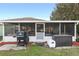 Spacious screened patio with hot tub, grill, and seating area at 13165 Sw 107Th St, Dunnellon, FL 34432