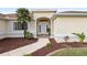 Inviting front door entrance with columns and landscaping at 13560 Se 90Th Ct, Summerfield, FL 34491