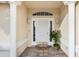 Elegant front entry with white door and welcome mat at 13560 Se 90Th Ct, Summerfield, FL 34491