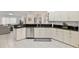 Well-equipped kitchen featuring granite countertops and white cabinetry at 13560 Se 90Th Ct, Summerfield, FL 34491