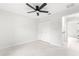 Spacious bedroom with white walls, tile floors, and a ceiling fan at 14108 Se 42Nd Ter, Summerfield, FL 34491