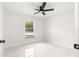 Bright bedroom with large window, tile floors, and ceiling fan at 14108 Se 42Nd Ter, Summerfield, FL 34491