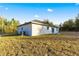 Side view of the house with AC unit and satellite dish at 14108 Se 42Nd Ter, Summerfield, FL 34491