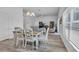 Bright dining room with white table and chairs near kitchen at 1789 Usrey Ct, Okahumpka, FL 34762