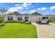 Single-story home with gray accents and a landscaped lawn at 1789 Usrey Ct, Okahumpka, FL 34762