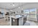 Kitchen island with seating and open concept to living area at 1789 Usrey Ct, Okahumpka, FL 34762