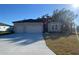 Charming single-Gathering home featuring a two-car garage, neutral color palette, and neatly maintained front lawn at 19448 Sw 78Th Pl, Dunnellon, FL 34432