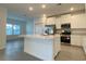 Modern kitchen featuring stainless steel appliances, white cabinets, and a center island with a sink at 19448 Sw 78Th Pl, Dunnellon, FL 34432