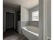 Modern bathroom with a bathtub and gray tile at 20653 Sw Audubon Ave, Dunnellon, FL 34431