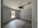 Bright bedroom with vinyl plank flooring and a large window at 20653 Sw Audubon Ave, Dunnellon, FL 34431