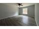 Simple bedroom with vinyl plank flooring and a window at 20653 Sw Audubon Ave, Dunnellon, FL 34431