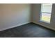 A clean bedroom featuring gray carpet, light gray walls, and a view of the outdoors at 2154 Nw 23Rd Loop, Ocala, FL 34475