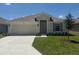 Charming one-story home with a well-manicured lawn and an attached two-car garage at 2154 Nw 23Rd Loop, Ocala, FL 34475