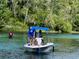 People enjoy the view from a boat on a clear lake at 2154 Nw 23Rd Loop, Ocala, FL 34475