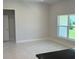A large window allows for lots of natural light in this open-concept living room with tile floors at 2154 Nw 23Rd Loop, Ocala, FL 34475