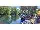 Scenic river view showing boats, trees, and a charming riverside patio, perfect for relaxation at 2154 Nw 23Rd Loop, Ocala, FL 34475