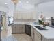 Open kitchen with white cabinets, quartz countertops, and a black farmhouse sink at 22287 Sw Mango Ln, Dunnellon, FL 34431