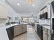 Modern kitchen with white cabinets, quartz countertops, and stainless steel appliances at 22287 Sw Mango Ln, Dunnellon, FL 34431