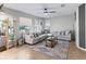 Cozy living room featuring a light grey sectional sofa, a coffee table and floor lamp at 22287 Sw Mango Ln, Dunnellon, FL 34431