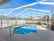 Screened pool area with patio furniture at 22287 Sw Mango Ln, Dunnellon, FL 34431