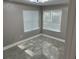 Bright bedroom with tile floors and window coverings at 23104 Sandalwood Dr # 104, Wildwood, FL 34785