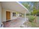 Back exterior featuring attached carport and a view of the backyard and trees at 2501 Nw 20Th St, Ocala, FL 34475