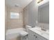 Bathroom featuring tile walls, a shower-tub combo, and a white vanity at 2501 Nw 20Th St, Ocala, FL 34475