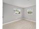 Bright bedroom featuring neutral walls, wood-look tile flooring, and windows providing natural light at 2501 Nw 20Th St, Ocala, FL 34475