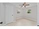 Bedroom showcasing a modern ceiling fan, neutral paint, tile floor, and natural light from the windows at 2501 Nw 20Th St, Ocala, FL 34475