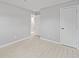 Neutrally decorated bedroom featuring tile floors, white trim, and a closet with white door at 2501 Nw 20Th St, Ocala, FL 34475