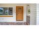 Close up on the front door with decorative mosaic tile porch and attached carport at 2501 Nw 20Th St, Ocala, FL 34475