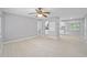 Open living space with tile flooring, light gray walls, ceiling fan and access to the kitchen at 2501 Nw 20Th St, Ocala, FL 34475