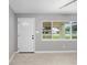 Living room features a window providing natural light and light colored tile flooring at 2501 Nw 20Th St, Ocala, FL 34475