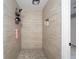 Updated walk-in shower featuring sleek tile, a rain shower head, and built-in niche for storage at 2501 Nw 20Th St, Ocala, FL 34475