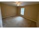 Second bedroom with neutral carpeting and a window at 28 Juniper Loop Ter, Ocala, FL 34480